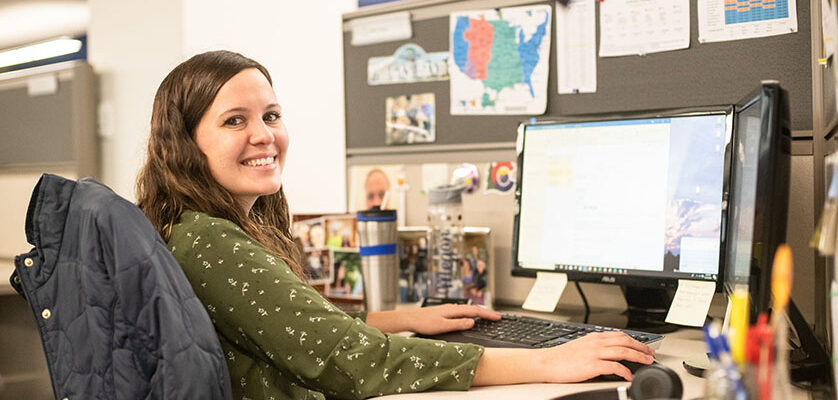 Woman smiling while sitting at her desk